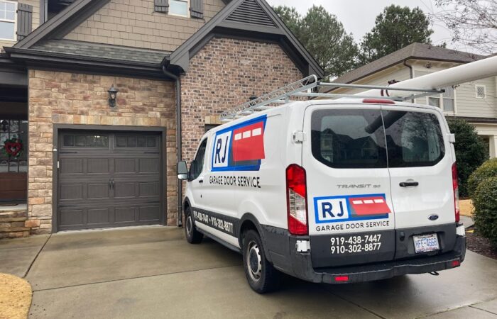 RJ Garage Door Service Car in front of a house