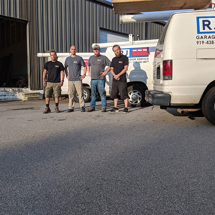 RJ Garage Door Service Team in front of the cars