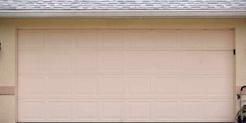 Wide garage double door and concrete driveway of new modern american house.