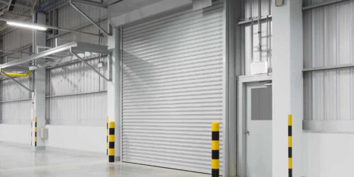 Roller shutter door and concrete floor outside factory building for industry background.