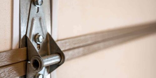 Garage door metal panel hinge