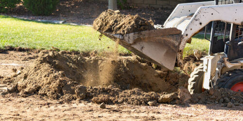 Small Bulldozer Digging In Yard For Pool Installation Small Bulldozer Digging In Yard For Pool Installation